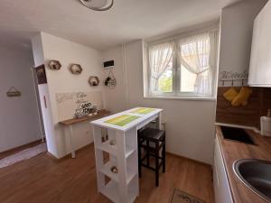 a kitchen with a white counter and a sink at Darius in Tuzla +8 photos