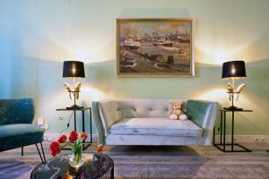 uma sala de estar com um sofá e um ursinho de peluche em Apartmenthaus Hamburg Les Jardins em Hamburgo