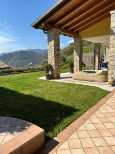 a patio with a couch under a pavilion at Casa Aaron in Tremosine Sul Garda