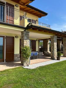 a house with a balcony and a patio at Casa Aaron in Tremosine Sul Garda