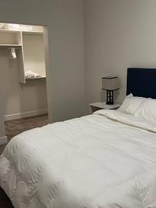 a bedroom with a white bed with a blue headboard at One bedroom apartment in Salt Lake City