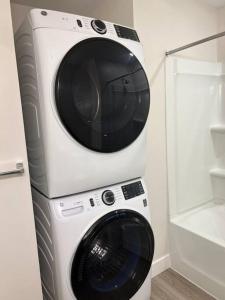 a dryer and a washing machine in a bathroom at One bedroom apartment in Salt Lake City