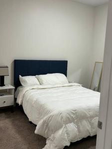 a bed with a blue headboard in a bedroom at One bedroom apartment in Salt Lake City