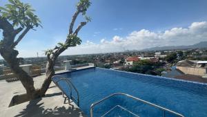 a swimming pool on the roof of a house at Azana Style Hotel Tulungagung in Tulungagung