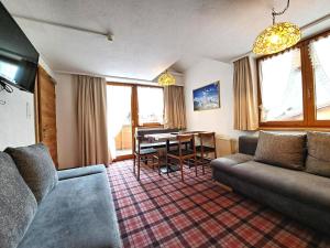 a living room with a couch and a table at Falkner Appartement Resort in Längenfeld
