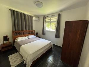 a bedroom with a bed and a window at Maison de 2 chambres avec vue sur la mer jardin clos et wifi a Gourbeyre a 1 km de la plage in Gourbeyre