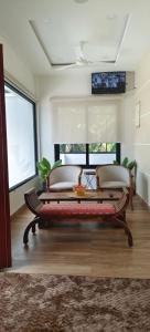 a living room with a bench and a table at Waterlily Homestay in Kottayam