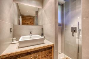 a bathroom with a sink and a shower at Appartement Chalet à Megève in Megève