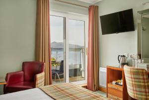 a hotel room with a bed and a large window at Clan Macduff Hotel in Fort William