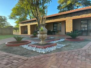 a large vase sitting in the middle of a yard at Azalea Accommodation in Northam