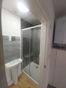 a bathroom with a shower and a sink at Masfol home from home in Oldham