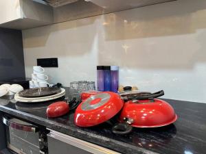 a kitchen with two red toasters on a counter at VelvetHouz Luxury Studio Apartment In Noida in Ghaziabad