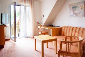 a living room with a couch and a table at Schweigerhof in Ismaning