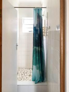 a shower with a blue shower curtain in a bathroom at Pumlani Kei Mouth in Kei-mouth Village