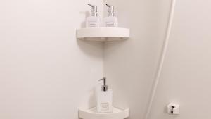 a bathroom with a sink and a toilet with a sink at Tabist MEN‘TEL Kitami in Kitami