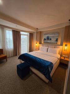 Postel nebo postele na pokoji v ubytování Perla Hotel