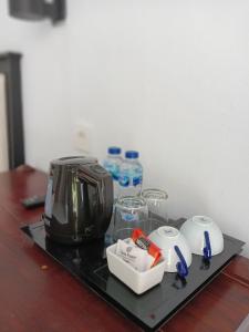 a tray with a toaster and other items on a table at New Mekar Jaya Hotel in Legian
