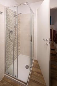 a shower with a glass door in a bathroom at All'Ombra della Torre in Viterbo