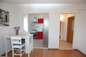 a kitchen with red cabinets and a white refrigerator at Babsi in Pula