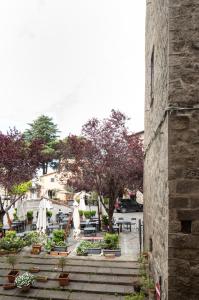 a view of a patio with tables and umbrellas at All'Ombra della Torre in Viterbo