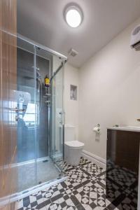 a bathroom with a glass shower and a toilet at Unit 2 Island View Apartments With Stunning Harbour View in Cobh