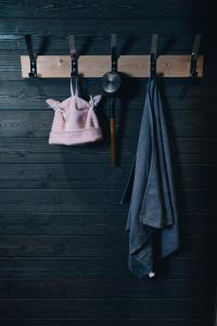 a rack with a towel and a hat and a coat at Hotel & Hostel Silmu in Evitskog
