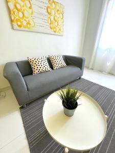 a living room with a couch and a table at SEAVIEW HOLIDAY APARTMENT 4 - WiFi & Netflix in Kuala Terengganu