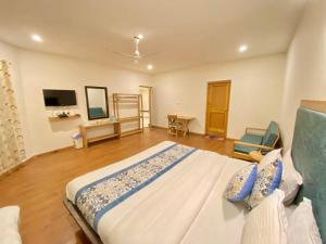 a bedroom with a large bed and a television at hotel palam hills in Leh