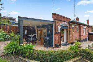 a small house with a courtyard with a patio at Mrs Percivals heritage luxury and romance with outdoor deep soak tub in Victor Harbor