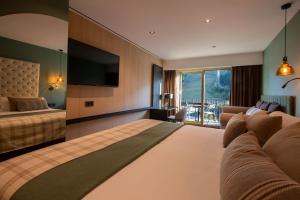 une chambre d'hôtel avec un lit et une télévision dans l'établissement Hotel Piolets Soldeu Centre, à Soldeu