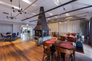 a living room with a fireplace and a table and chairs at Peoleo Hotell in Tallinn