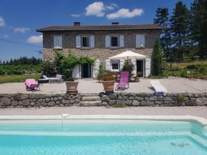 a house with a swimming pool in front of a house at Cosy Room in Saint-Romain-Lachalm