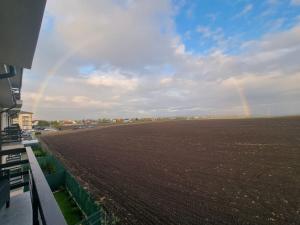 einen Blick auf ein Feld mit Regenbogen am Himmel in der Unterkunft Sunrise paradise in Suceava