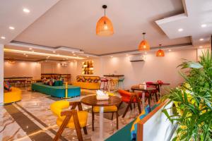 ein Restaurant mit farbenfrohen Möbeln, Tischen und Stühlen in der Unterkunft goSTOPS Gurugram in Gurgaon
