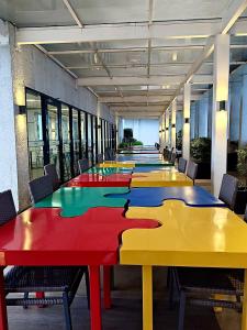 a long row of tables in a room with chairs at Casa Luna Unit 1 in Manila
