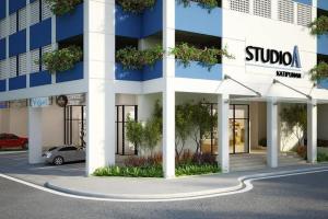 a blue and white building with a car parked outside at Casa Luna Unit 1 in Manila