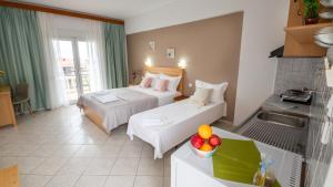 a hotel room with two beds and a sink at House Elena in Koinyra