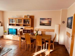 a dining room with a wooden table and chairs at Ferienhaus Dycke 6 in Zudar