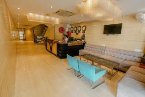 a lobby with a couch and a bar with a person at Dazzling in Agra