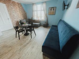 a living room with a couch and a table at Central Sopot in Sopot +82 photos