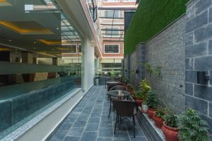 a courtyard with tables and plants in a building at Hotel Crystal Pashupati in Kathmandu