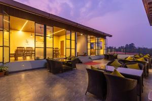 an outdoor patio with couches and chairs at night at Hotel Crystal Pashupati in Kathmandu