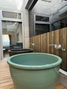 un bagno con grande vasca verde di EarthVeloビル一棟貸しでフルリノベ済み各階に風呂トイレありで好立地でコスパ最高をめざしている宿です a Tokushima