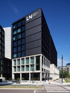 a black building with a lmn sign on it at Little National Hotel Newcastle in Newcastle