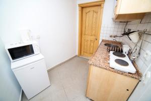 a small kitchen with a sink and a stove at Fethiye Suites Downtown in Fethiye