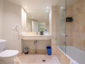 a bathroom with a toilet and a sink and a shower at Cosy Studio with Stunning Ocean Views in Gold Coast