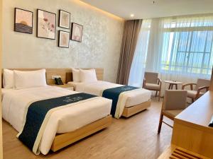 Postel nebo postele na pokoji v ubytování The Hub Hotel near Phu Quoc airport and harbor