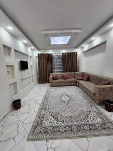 a living room with a couch and a rug at Jordan home in Irbid