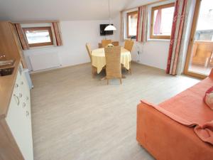 a kitchen and dining room with a table and chairs at Spacious Apartment in Uderns near Ski Area in Uderns