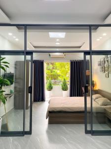a bedroom with a bed and a window at Calmette Home in Ho Chi Minh City